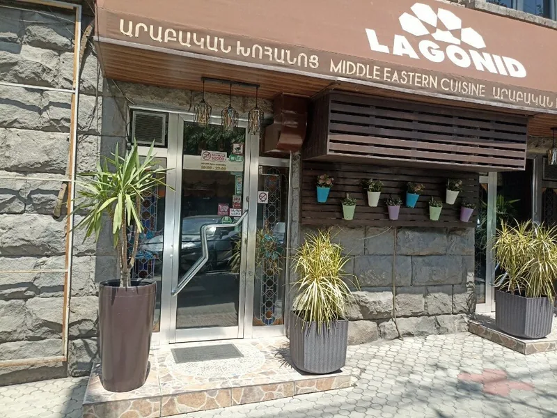 Glass door of Lagonid with flower pots on the wall