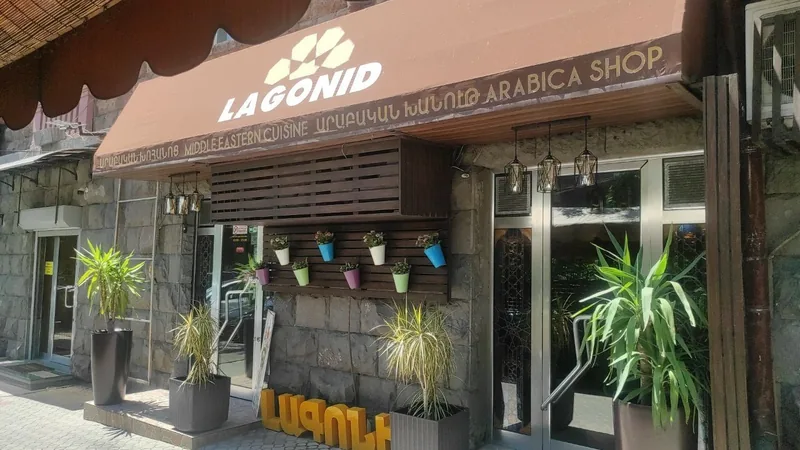 Lagonid entrance on Nalbandyan Street with the brown awning and potted palms